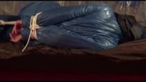 Alina tied, gagged and hooded on a princess bed in an old cellar wearing a shiny blue downwear (Video)