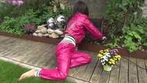 Watching Aiyana wearing supersexy pink shiny nylon rainwear while planting flowers in the garden (Video)