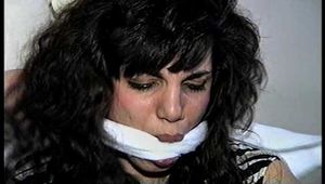 35 YEAR OLD ITALIAN HAIRDRESSER IS CLEAVE GAGGED, MOUTH STUFFED WITH PANTIES, HANDGAGGED, WHILE TIGHTLY TIED TO A CHAIR (D74-14)