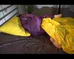 Lucy wearing a purple rain suit preparing her bed cloths for enjoying herself and the rain suit in bed lolling around (Video)