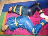 Stella and Leonie tied and gagged and hooded with tape both wearing sexy shiny nylon rainwear (Pics)