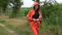 Miss Petra takes a walk in a orange AGU rain suit and rubber boots