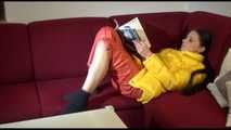 Watching sexy Lucy wearing a orange/yellow shiny nylon downwear combination reaing a magazine and lolling on the sofa (Video)