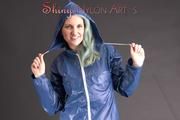 Mara posing in the studio wearing a blue rain skirt and a blue rain jacket as wellas red rubber boots (Pics)