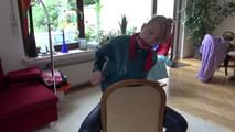 Mara tied and gagged on a chair with a bar wearing a sexy blue shiny nylon rain pants and a green rain jacket (Video)