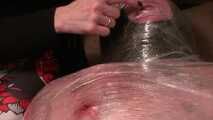 Foiled slave with a bloody nipple