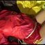 Lucy tied and gagged on bed wearing a red/yellow shiny nylon shorts and a red rain jacket (Video)