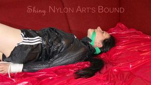 LUCY tied and gagged with ropes and a cloth gag on a sofa wearing a supersexy black shiny nylon shorts and black rain jacket (Pics)