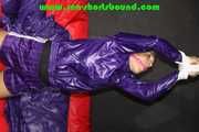 Sandra being tied and gagged overhead with ropes, a bar and a ballgag wearing sexy purple shiny nylon shorts and rain jacket (Pics) 