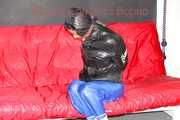 Sonja wearing a sexy blue shiny nylon raver pants and a black down jacket being tied and gagged with ropes on a sofa (Pics)