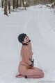 Naked barefoot brunette chained in the snow