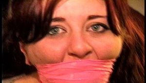 23 YR OLD REAL ESTATE BROKER IS WRAP BONDAGE TAPE GAGGED, MOUTH STUFFED, CLEAVE GAGGED, HANDGAGGED, BANDANNA GAGGED, GAGS ON A SPONGE, GAG-TALKING, NYLON COVERED BARE FEET AND TIED TO A CHAIR 