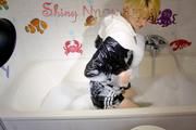 Sonja taking a bath wearing a sexy black shiny nylon shorts and a rain jacket playing with the foam and the water as well as her clothes (Pics)