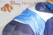 Watching Sonja taking a foam bath  wearing sexy blue shiny nylon rainwear (Pics)