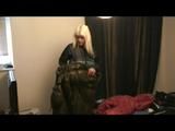 Blonde-haired archive girl going out wearing shiny nylon rainwear (Video)