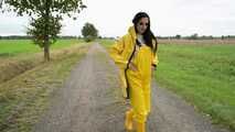 Miss Amira on the road in a Frisian mink, yellow rain dungarees and rubber boots