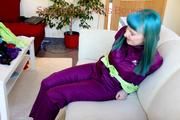 Mara tied and gagged with cloths on a sofa wearing a sexy purple shiny nylon rainwear (Pics)