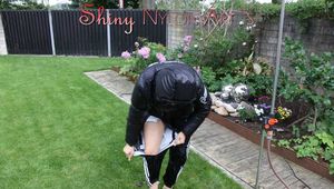 Watching sexy Aiyana wearing a supersexy black shiny nylon rainpants and a black down jacket playing with water of the garden shower and destroying her pant (Pics)