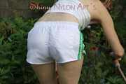 Watching sexy Sonja wearing white shiny nylon shorts and a top during watering the garden (Pisc)