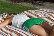 Sexy Sandra lying in the sun and feeling good wearing a green shiny nylon shorts and a white tshirt (Pics)