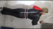 Pia tied, gagged and hooded in a cellar overhead wearing shiny nylon rainwear in black (Video)