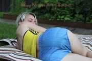 Sexy Sonja wearing a lightblue shiny nylon shorts with a yellow top durig her bath in the sun (Pics)
