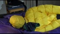 Pia tied, gagged and hooded on bed with cuffs and a gag wearing a hot darkblue rain pants and a big yellow down jacket (Video)