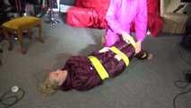 See Sophie tied and gagged by Ronja in shiny Downwear