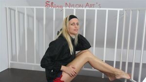 Sabrina posing on a stairway wearing a sexy shiny nylon shorts and playing with her black rain jacket (Pics)