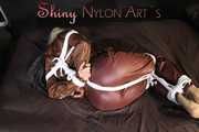 Watching sexy Sonja being tied and gagged on a bed with ropes and a clothgag wearing a supersexy shiny brown nylon pants and a brown rain jacket (Pics)