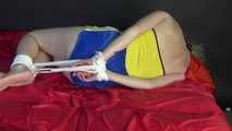 ***NEW MODELL MIA*** wearing a sexy yellow/blue shiny nylon shorts and a yellow top being tied and gagged with ropes and a clothgag on a bed (Video)