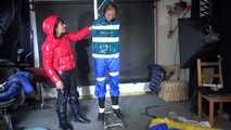 See Ronja tied, gagged and suspended by Stella, both wearing shiny nylon Downwear