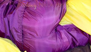 Lucy wearing a supersexy purple rain suit with hood while preparing her bed (Pics)