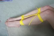 Lucy hogtied with thin yellow rope