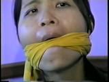 24 Yr OLD VIETNAMESE DAISY IS CLEAVE GAGGED, BAREFOOT, MOUTH STUFFED WITH NYLON ANKLE STOCKING, STUFFS HER OWN MOUTH, TIED ON BED & HANDGAGGED WITH BLACK LEATHER GLOVE (D55-5)