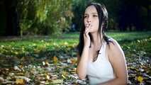 Smoking in the autumn park with lovely lady