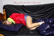 Samantha tied and gagged in a shiny light blue nylon shorts and a red shiny rainjacket (Pics) 