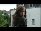 Alina coming home and lolling on the balcony wearing shiny nylon rainwear (Video)
