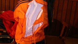 Jill wearing a sexy black nylon shorts and a orange rain jacket while dressing her up (Pics)