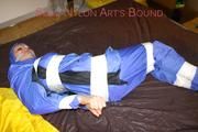 Lucy tied, gagged and hooded with tape by Sophie on bed wearing sexy lightblue rainwear (Pics)