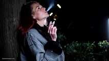 Mature woman smoking outdoors