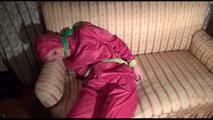 Mara tied and gagged with cloths on a sofa wearing sexy pink shiny nylon rainwear (Video)