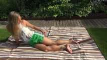 Watching sexy Sandra wearing a sexy green shiny nylon shorts and a white top taking a sun bath (Video9