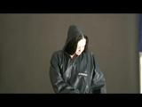 Blackhaired archive girl posing infront of the camera wearing supersexy black rainwear (Video)