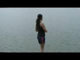 Enni wearing sexy shiny nylon shorts and top while throwing stones in a lake (Video)