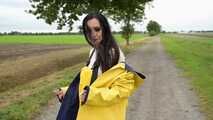 Miss Amira on the road in a Frisian mink, yellow rain dungarees and rubber boots