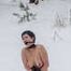 Naked barefoot brunette chained in the snow