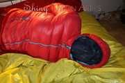 Watching sexy Jill wearing a red shiny nylon rain pants and an oldschool rain jacket under a red downjacket being tied and gagged with ropes and a ballgag on a bed (Pics)