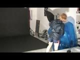 Blonde archive girl posing on a blowable chair wearing shiny nylon shorts and a rain jacket (Video)