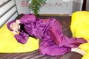 Lucy wearing a supersexy purple rain suit with hood while preparing her bed (Pics)